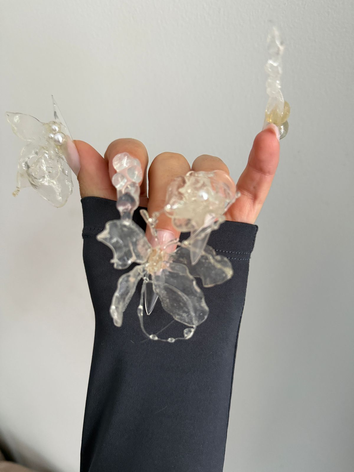 Hands with sculpted clear-resin floral nails